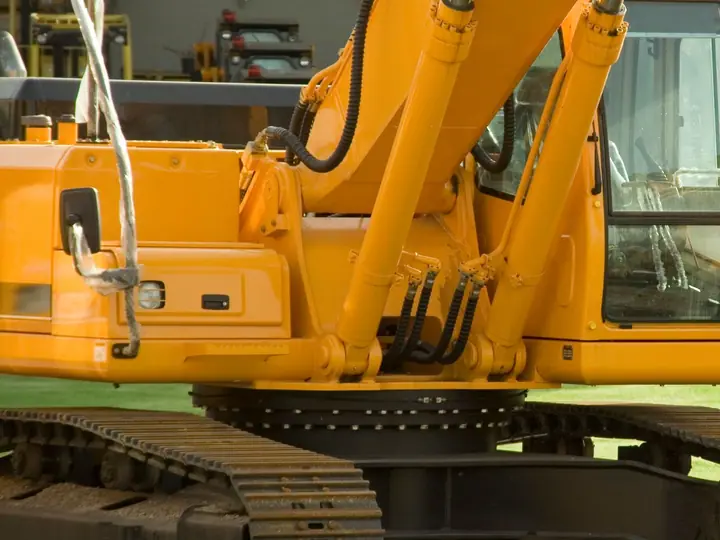 Yellow excavators lined up in an industrial equipment yard